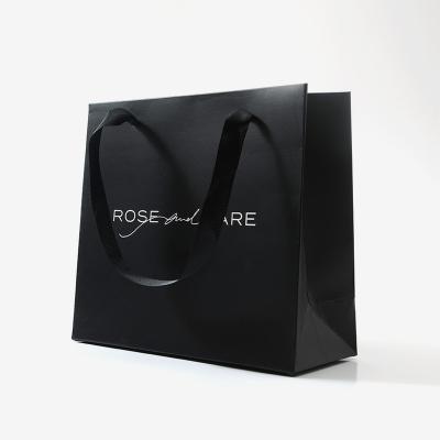 China Custom Printed Paper Bag Luxury Handmade Logo Jewelry Packaging Kraft Shopping Gift Paper Bag Black With Ribbon Handles for sale