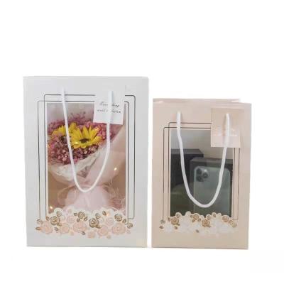 China Recycled Materials Custom Printed Brown Kraft Paper Shopping Bags With Clear Handle Luxury Boutique Paper Bags for sale