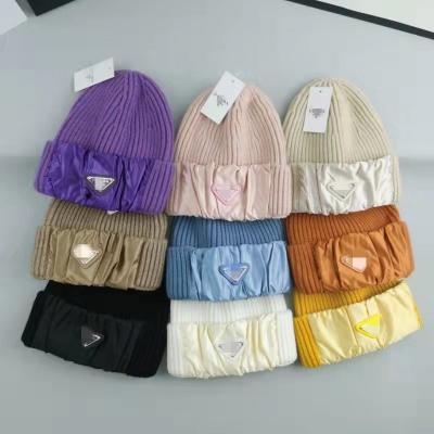 China COMMON luxury brand new designer fashion winter knitted hat skullcap inverted triangle metal logo brand hat for sale