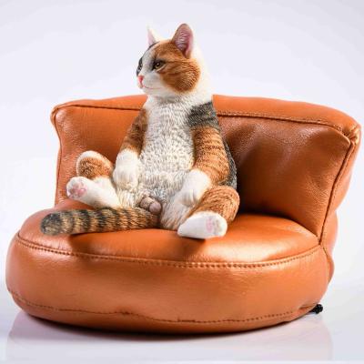 China Custom Europe Resin Cat Statue Sitting on Sofa Resin Crafts for Wholesale Resin Animal Figurines for sale