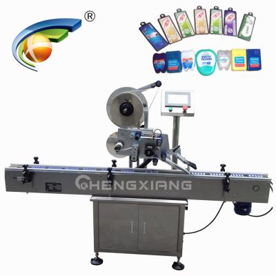 China automatic beverage paging and labeling machine for card box box, top labeling machine factory en venta