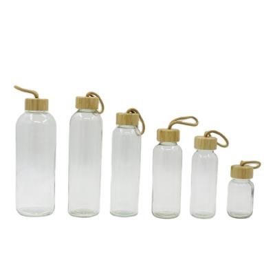 China 150ml 300ml 420ml 500ml 750ml 1000ml Viable Leakproof Transparent Glass Water Bottle With Bamboo Screw Lid for sale