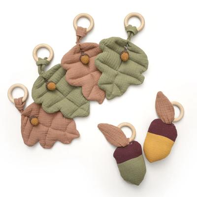 China Soft Pendant Ring Pine Nut Leaf Wooden Baby Rattle Pendant for sale