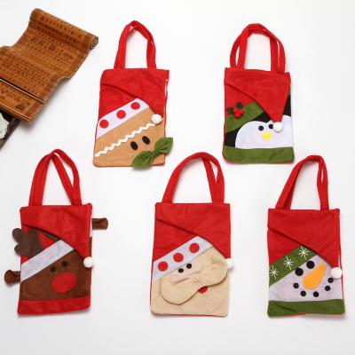 China Non-woven Christmas Elks And Bears Gift Bag Christmas Cartoon Candy Wrapper Santa Plastic Bag for sale