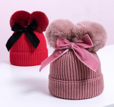 China Autumn and winter knitting character cute double ball bow children's hat with cotton baby hat hot wholesale for sale