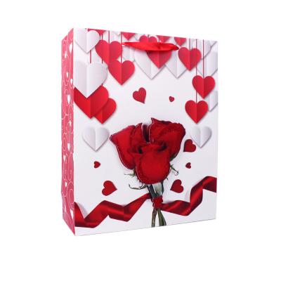 China Recyclable Valentine's Day Three Blooming Red Roses Pattern Custom Logo Printed Paper Bag For Gift Clothes for sale