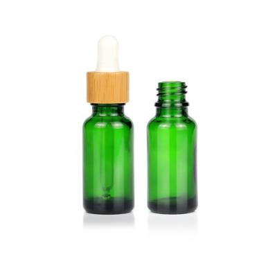 China Custom Cosmetic Bamboo Green Glass Dropper Cap 20ml Essential Oil Dropper Bottles for sale