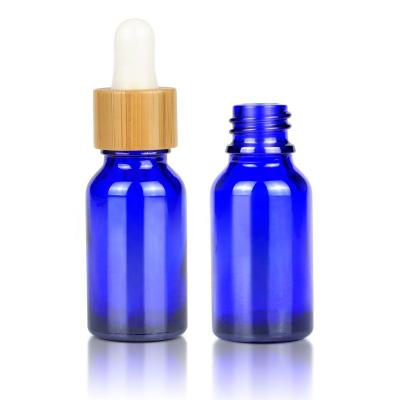 China Private Label 15ml Essential Oil Cosmetic Wholesale Bottle Blue Glass Bottle With Bamboo Dropper Cap for sale