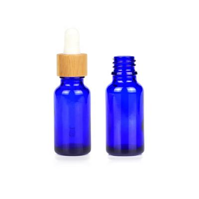 China Hot Selling Luxury Blue Custom Bamboo Glass Bottle 20ml Dropper Cap Essential Oil Cosmetic Bottles for sale