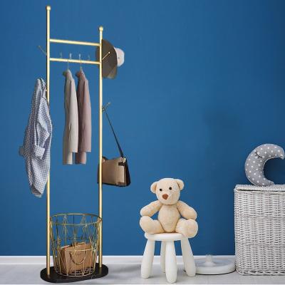 China Metal Floor Coat Rack Eco-friendly Type Creative Lightweight Luxury Golden Clothes Stand Coat Racks With Storage Basket for sale