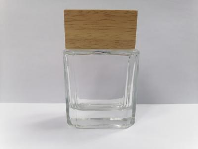 China 50ml Glass Perfume Bottles With Wooden Cap Transparent Makeup Packaging Various Color And Printing for sale