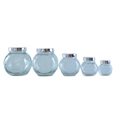 China Wholesale 50g 100g Beverage Sets Glass Storage Jar Flat Drum Bottle With Metal Cap for sale