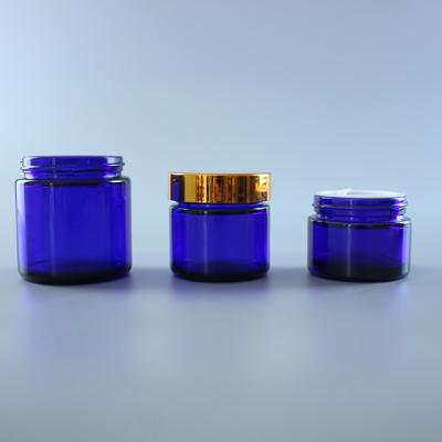 China Screen Printing Shoulder Shape 15g 30g 50g Cobalt Blue Oblique Cosmetic Empty Packaging Glass Cream Jar Container With Black Lid for sale