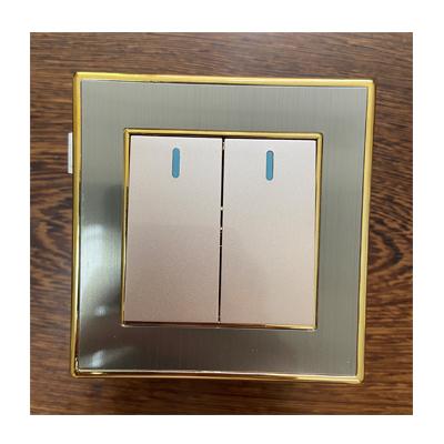 China UK Standard Gold Plated Frame Stainless Steel 2 Gang 1 Way Switch for sale