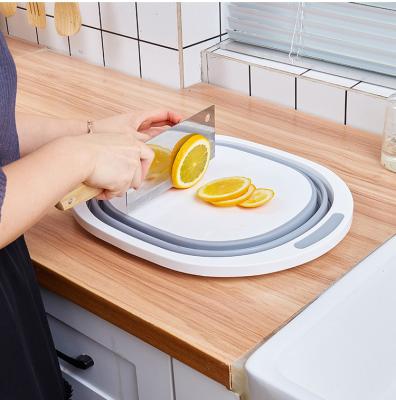 China PP Viable Cutting Board Foldable Multifunctional Kitchen Fruits Food Grade Folding Chopping Board With Colander Storage for sale