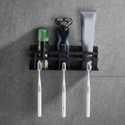 China Simple Convenient Wall Mount Toilet Toothpaste Toothbrush Rack Punchless Stainless Steel Bathroom Toothbrush Storage Holder for sale