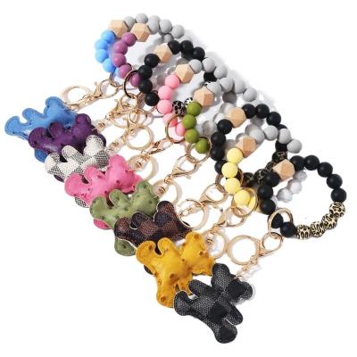 China 2021 New Design Key Chain Sinicone Wood Bead Bracelet Bear Key Chain Key Chain Pendant Bag for sale