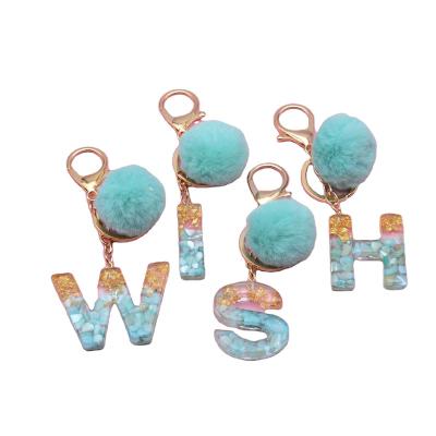 China Gift Letter New 26 Key Chain Green Shell Gold Foil Glue Resin English Faux Fur Pom Keychain for sale