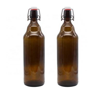 China High Quality 750ml Round Glass Wine Bottles Wholesale Amber Wine Bottle With Swinging Cap for sale