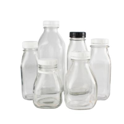 China Wholesale 8oz 12oz 14oz 32oz Fancy Beverage Square Milk Bottle Square Glass Bottle for Milk with Plastic Lid for sale