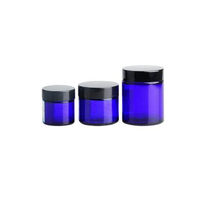 China Personal Care Cylinder Jar 10g Skin Cream Blue Cream Glass Jar With Black Lids In Store for sale