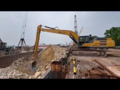 Excavator long arm with unloading bucket for unloading at jetty