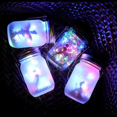 China Outdoor Waterproof Solar Powered Mason Jar Fairy Lights Garden Hanging Hand Etched Light Mason Bottle Night Light for sale