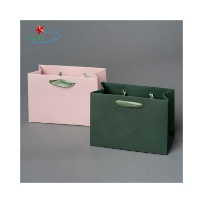 China Recyclable Pink Paper Bag Maker Kraft Paper Bag With Rope Handle for sale