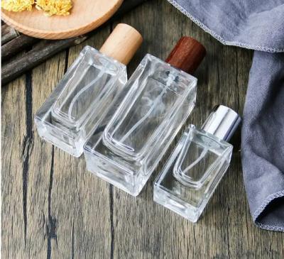 China Wholesale Empty Perfume Bottle Rectangle Perfume Bottle Packaging 30ml 50ml 100ml Glass Perfume Bottle with Wood Cap for sale