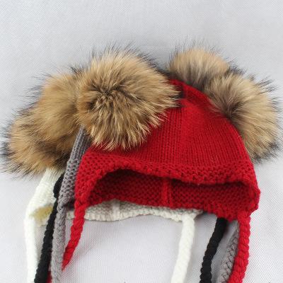 China JOINT Children Knitted Raccoon Fur Hat With Double Ball Protect Ears for sale