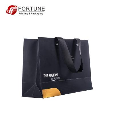 China Recycled Materials Customized Logo Low Price Packing Black Bulk Gift Paper Bags For Clothes for sale