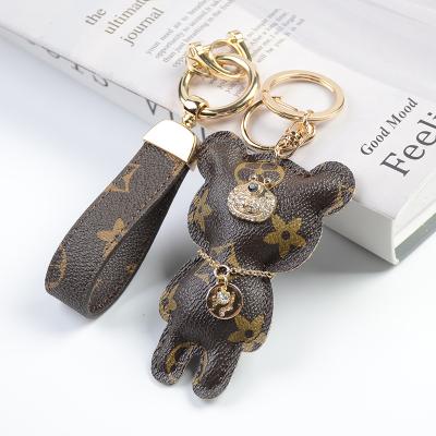 China Luxury Plastic Designer Keychain, Custom Sublimation Mirror Key Chain, Dog Design Leather Wristband Wholesale 3D Key Chain for sale