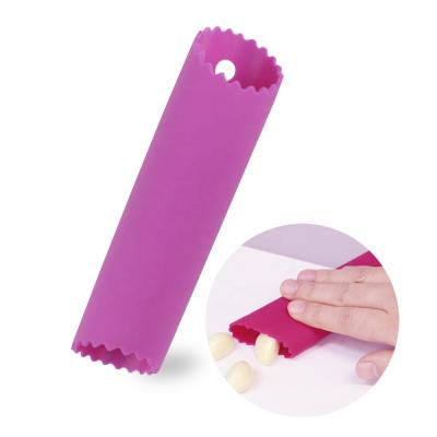 China Viable Small Food Grade Kitchen Peeling Tools Easy To Clean Rrolling Manual Silicone Garlic Press for sale