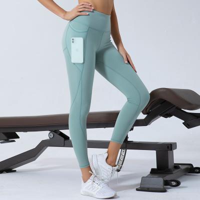 China Fashion fitness and yoga wear breathable leggings for women leggings with high pocket waist yoga pants longs solid color tiktok leggings for sale