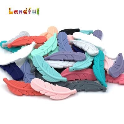 China Soft Silicone Baby Toy Soft Chewable Feather Shape Teether Pendant for Newborn Infant for sale