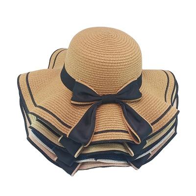 China Picture summer sunscreen hat with large brim wavy bow ladies beach hat papyrus outdoor straw hat for sale