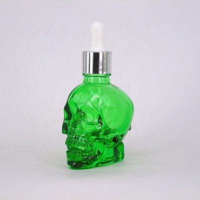 China Personal Care Skull Shaped Bitter Dasher Glass Bottle for sale