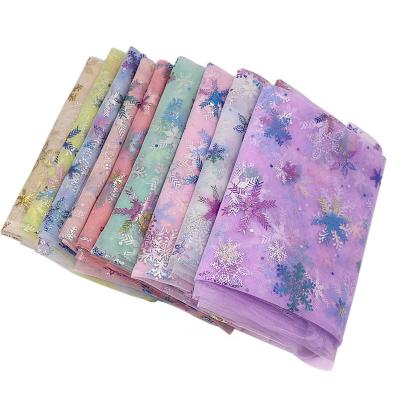 China Wholesale High Quality Colorful Laser Snowflake Tulle Fabric Shrink-Resistant For Party Decoration Wedding for sale