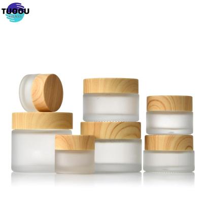 China Cosmetic Hot sale bottle Frosted Jar Lid Cosmetics Cream Glass Bottles And Jars Bamboo Cosmetic Packaging container for sale