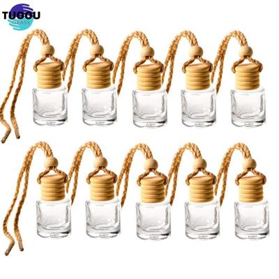 China Perfume bottle Car four empty mounted wooden cover perfume pendant glass container in car odor removing essential oil separate bottles for sale