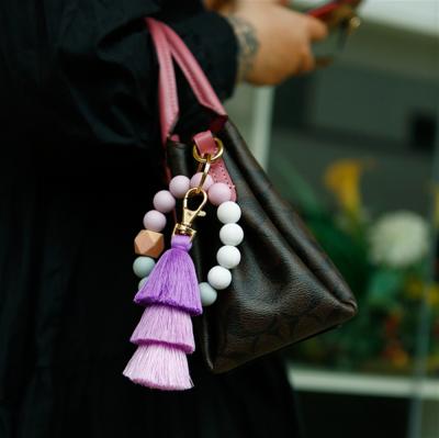 China Hot Selling Bead Key Chain Bracelet Bags Food Grade Silicone Three-Layer Tassel Wooden Elastic Rope Bracelet for sale