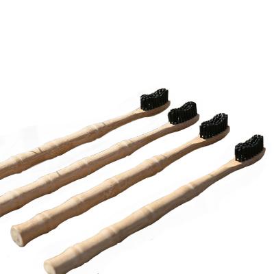 China Adult Disposable Bamboo Toothbrush Soft Black Wavy Bamboo Charcoal Finish Toothbrush Supports Correction Customized for sale