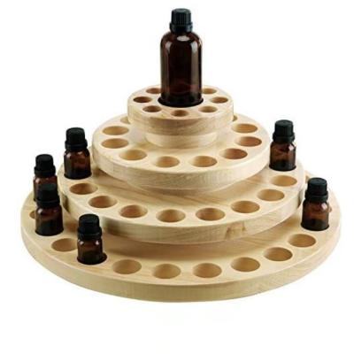 China New Europe Natural Wood Round 4-Tier Rotating Essential Oil Bottle Holder Storage Display Rack for sale