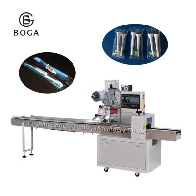 China Automatic Pillow Type Disposable Toothpaste Toothbrush Comb Packaging Machine CLOTHING Pillow Low Price for sale