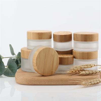 China Personal Care With Bamboo Wood Lid Eco - Friendly Classic Cosmetic Frosted Glass Cream Jar for sale