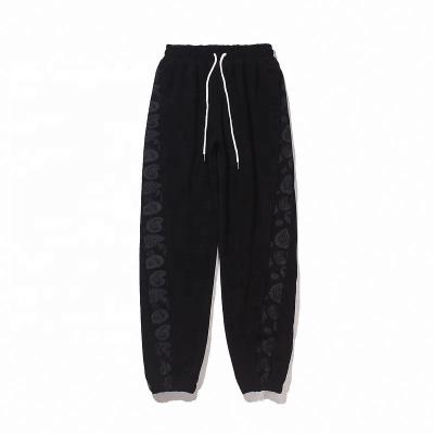 China Anti-Wrinkle OEM Customized Mens Sports Pants Loose Hip Hop Cashew Print Casual Pants for sale