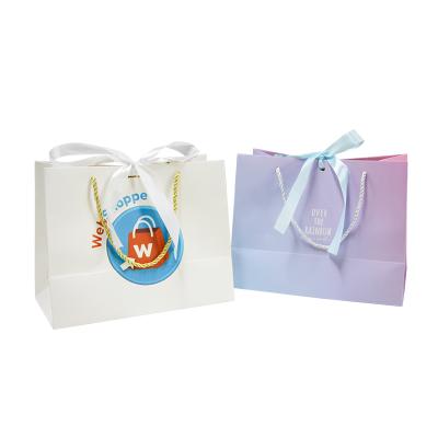 China 2022 recyclable in stock luxury boutique shopping bag fashion paper gift bags with ribbon custom paper bags for clothing for sale