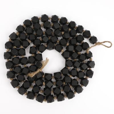 China 88 Pcs Eco-friendly Black Christmas Hexagon Wooden Bead Garland With Tassels For Home Decor for sale