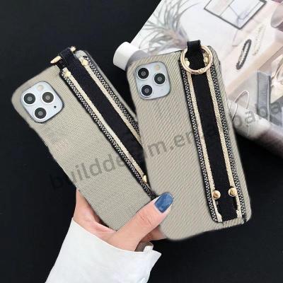 China Shockproof Genuine Leather Wrist Strap Rivet Phone Case For iPhone 12 13 13 X XS Max for sale