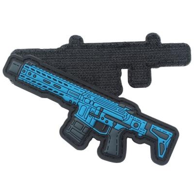 China Custom 3D Raised Logo Soft Morale Gun PVC Patches With Hook And Loop Fasteners for sale